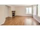 Spacious living room featuring a cozy fireplace and large window at 1145 S Boston St, Denver, CO 80247