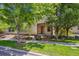 Charming home featuring lush trees, beautiful architectural detail and a well-kept lawn at 2230 Valentia St, Denver, CO 80238