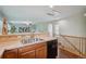 Kitchen with tile counters, wood cabinets, and a view of the living area at 2230 Valentia St, Denver, CO 80238