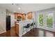 Kitchen with stainless steel appliances, bar seating, and access to an outdoor patio at 2230 Valentia St, Denver, CO 80238