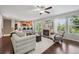 Open-concept living room with fireplace, and views into kitchen with bar seating at 2230 Valentia St, Denver, CO 80238