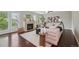 Bright living room featuring a fireplace, hardwood floors, and access to an outdoor patio at 2230 Valentia St, Denver, CO 80238