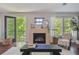 Cozy living room with natural light, fireplace, and patio access at 2230 Valentia St, Denver, CO 80238