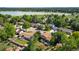 Aerial view of neighborhood with mature trees, and a park and lake in the distance at 6411 W 82Nd Dr, Arvada, CO 80003