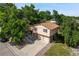 Aerial view of a landscaped home with mature trees and a driveway leading to a two-car garage at 6411 W 82Nd Dr, Arvada, CO 80003