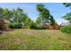 View of a large, grassy backyard with mature trees and a wooden fence at 6411 W 82Nd Dr, Arvada, CO 80003
