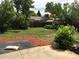 Backyard featuring a patio, lawn, mature trees, shrubs, and wooden fencing at 6411 W 82Nd Dr, Arvada, CO 80003