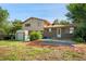 Spacious backyard with mature trees and a shed for extra storage and brick accents at 6411 W 82Nd Dr, Arvada, CO 80003