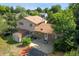 Aerial view of a cozy backyard with a patio, storage shed, and mature trees surrounding the home at 6411 W 82Nd Dr, Arvada, CO 80003