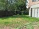 A spacious backyard features a storage shed and a wooden fence surrounded by mature trees at 6411 W 82Nd Dr, Arvada, CO 80003