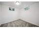 Finished basement featuring neutral carpeting and two egress windows for natural light at 6411 W 82Nd Dr, Arvada, CO 80003
