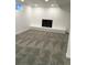 Finished basement featuring a painted brick fireplace and neutral carpeting at 6411 W 82Nd Dr, Arvada, CO 80003