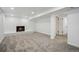 Finished basement area with a fireplace, neutral carpet, recessed lighting, and white-painted brick accent wall at 6411 W 82Nd Dr, Arvada, CO 80003