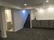 Finished basement with gray cabinets, a modern sink, and plush carpeting at 6411 W 82Nd Dr, Arvada, CO 80003