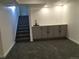 Finished basement with gray cabinets, a modern sink, and plush carpeting at 6411 W 82Nd Dr, Arvada, CO 80003