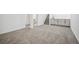 Spacious basement area features modern gray cabinets, stairs, and neutral carpeting at 6411 W 82Nd Dr, Arvada, CO 80003