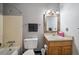 Full bathroom featuring a shower and tub combination with a stylish wooden vanity at 6411 W 82Nd Dr, Arvada, CO 80003