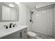 Modern bathroom featuring subway tile shower, matte black hardware, gray vanity and hexagon tile flooring at 6411 W 82Nd Dr, Arvada, CO 80003