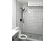 Bathroom featuring subway tile, a modern showerhead, and neutral walls at 6411 W 82Nd Dr, Arvada, CO 80003