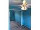 A bright blue bedroom featuring mirrored closet doors, carpeted floors, and a lighted ceiling fan at 6411 W 82Nd Dr, Arvada, CO 80003
