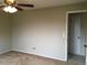 Bedroom with neutral walls, plush carpeting, ceiling fan and a view of the door at 6411 W 82Nd Dr, Arvada, CO 80003