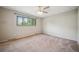 Comfortable bedroom with large window, neutral walls, and cozy carpeting at 6411 W 82Nd Dr, Arvada, CO 80003
