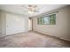 Bright bedroom with a large window, ceiling fan, and carpet at 6411 W 82Nd Dr, Arvada, CO 80003