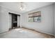 Well-lit bedroom featuring an open closet system, neutral carpet, and large window at 6411 W 82Nd Dr, Arvada, CO 80003