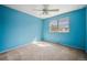 Cozy bedroom featuring natural light from the window, blue walls, and neutral carpet at 6411 W 82Nd Dr, Arvada, CO 80003