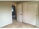 Bedroom with large closet and carpeted floors, leading to another room at 6411 W 82Nd Dr, Arvada, CO 80003