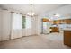 Open-concept dining room and kitchen with natural light from two large windows at 6411 W 82Nd Dr, Arvada, CO 80003