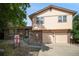 Two story home featuring brick and siding, with a well maintained lawn at 6411 W 82Nd Dr, Arvada, CO 80003