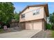 Two story home featuring brick and siding, with a well maintained lawn at 6411 W 82Nd Dr, Arvada, CO 80003