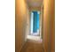 Hallway with neutral walls and carpet, showcasing doorways to other rooms with complementing trim at 6411 W 82Nd Dr, Arvada, CO 80003