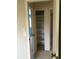Hallway featuring a storage closet and doorways to other rooms with neutral colored walls and carpeting at 6411 W 82Nd Dr, Arvada, CO 80003