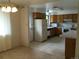 Well-lit kitchen with oak cabinetry and white appliances with an open layout at 6411 W 82Nd Dr, Arvada, CO 80003