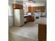 Bright kitchen featuring white appliances and countertops with oak cabinetry at 6411 W 82Nd Dr, Arvada, CO 80003