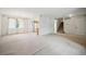 Spacious living room with a view of a staircase, a kitchen, and a large window at 6411 W 82Nd Dr, Arvada, CO 80003