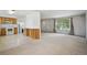 A living room and kitchen combo that includes a bar, a large window, and a staircase at 6411 W 82Nd Dr, Arvada, CO 80003