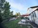 A spacious backyard with lush lawn, patio furniture, and a playset, perfect for outdoor living and entertaining at 5255 S Waco St, Centennial, CO 80015