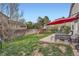 Lush backyard with patio, seating, play set, and mature trees at 5255 S Waco St, Centennial, CO 80015