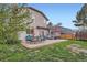 Spacious backyard features a patio with multiple seating areas and lush green grass at 5255 S Waco St, Centennial, CO 80015