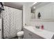 Clean bathroom with a light grey vanity and a fun pineapple print shower curtain at 5255 S Waco St, Centennial, CO 80015