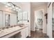 Dual sink bathroom with marble countertops and vanity lighting, plus a linen closet at 5255 S Waco St, Centennial, CO 80015