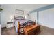 Bright bedroom featuring a cozy quilt bed, white shiplap, and ample closet space at 5255 S Waco St, Centennial, CO 80015