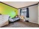 bedroom with lime green accent wall, window with blinds, and a twin bed with a playful aesthetic at 5255 S Waco St, Centennial, CO 80015