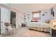 Charming bedroom with hanging chair, desk, and soft pink accents for a cozy feel at 5255 S Waco St, Centennial, CO 80015