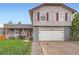 Beautiful exterior featuring a well-manicured lawn and two-car garage at 5255 S Waco St, Centennial, CO 80015
