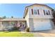 Charming two-story home featuring a well-manicured lawn, red window shutters, and a welcoming front porch with an American flag at 5255 S Waco St, Centennial, CO 80015