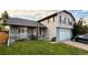 Charming two-story home with well-manicured lawn, inviting porch, and attached garage at 5255 S Waco St, Centennial, CO 80015
